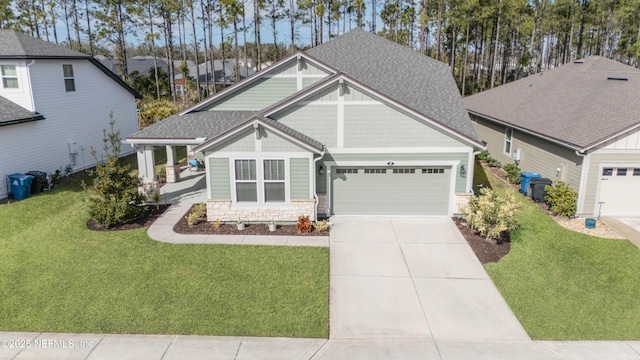 craftsman-style home featuring a garage and a front lawn