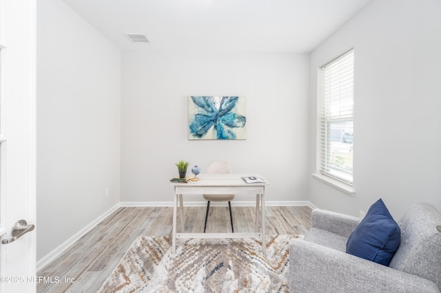 office with light hardwood / wood-style floors