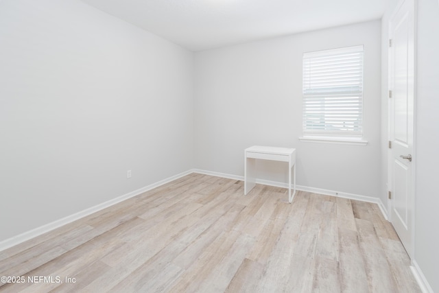 empty room with light hardwood / wood-style flooring