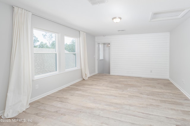 unfurnished room with light wood-type flooring