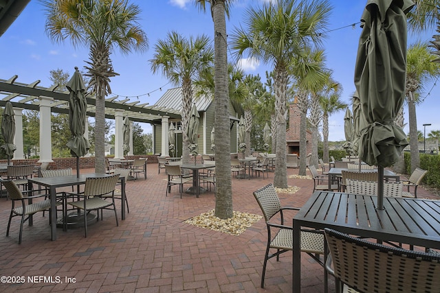 view of patio / terrace with a pergola and a fireplace