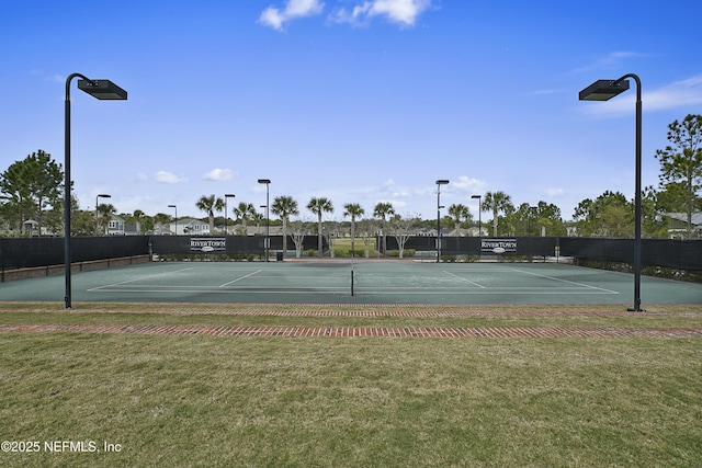 view of sport court featuring a lawn