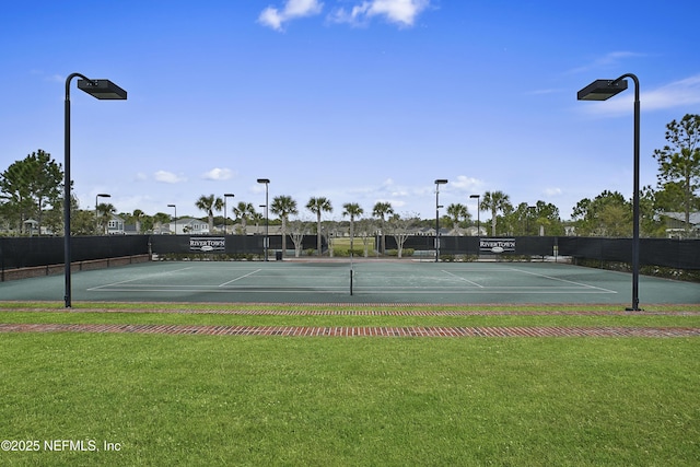 view of sport court with a yard