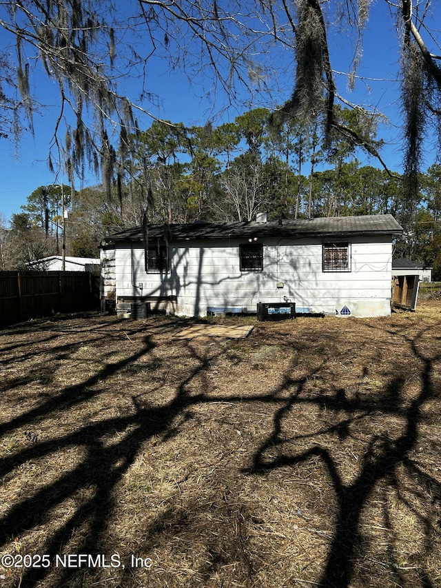 back of property featuring a yard