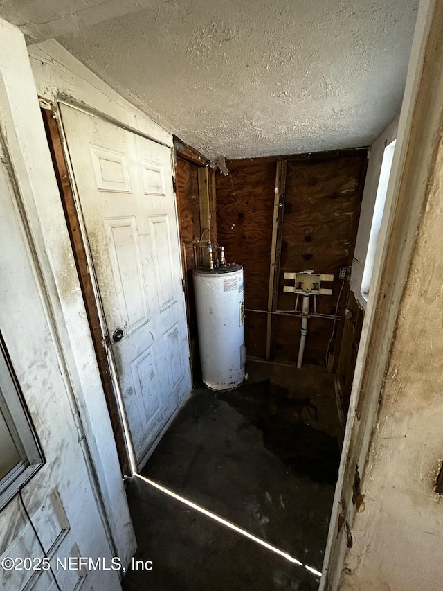 bathroom with water heater and a textured ceiling