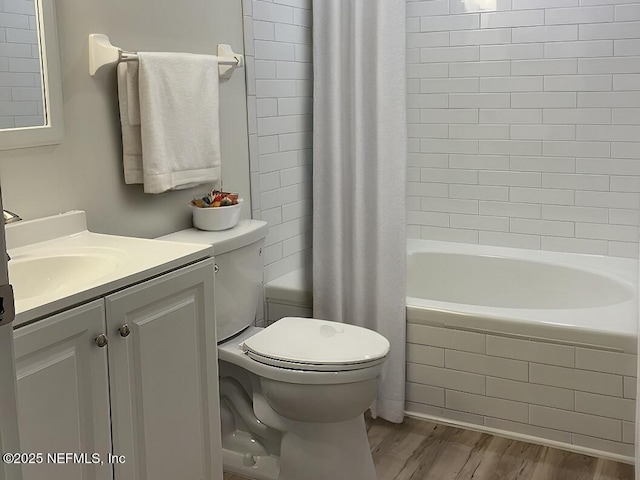 full bathroom with wood-type flooring, shower / bath combo, vanity, and toilet