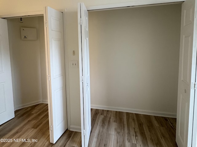 corridor with hardwood / wood-style floors