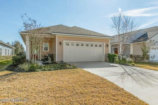 ranch-style home with a garage and a front lawn