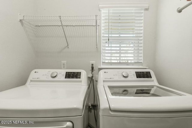 laundry room with washing machine and clothes dryer