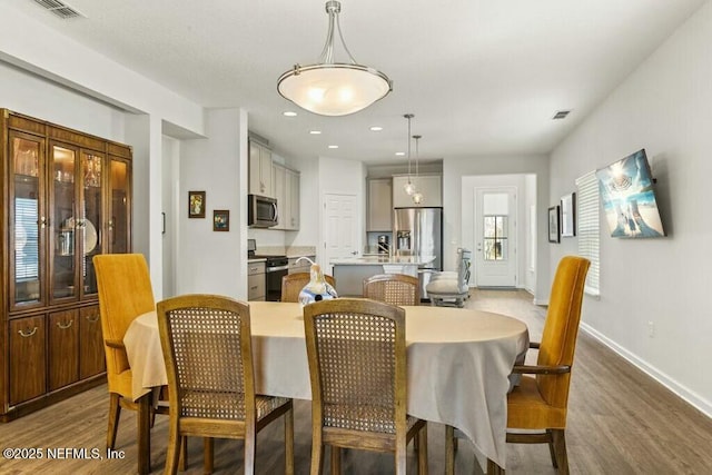 dining space with dark wood-type flooring