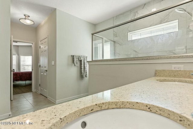 bathroom featuring walk in shower and vanity