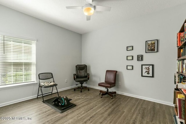 living area featuring hardwood / wood-style flooring and ceiling fan