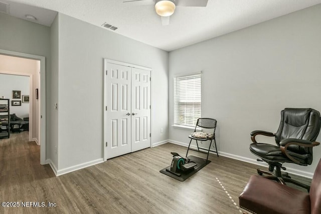 sitting room featuring hardwood / wood-style flooring and ceiling fan