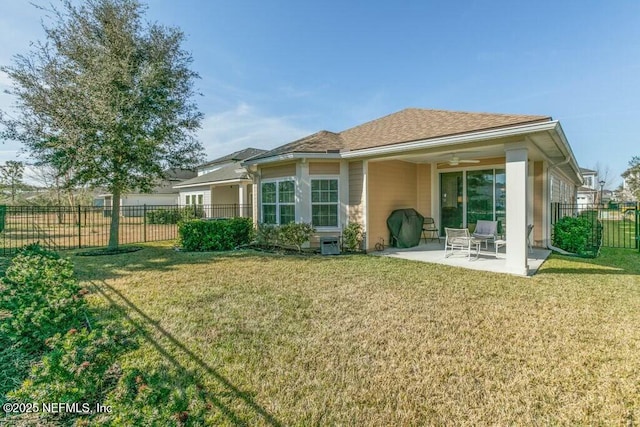 rear view of house with a yard, a patio area, and ceiling fan