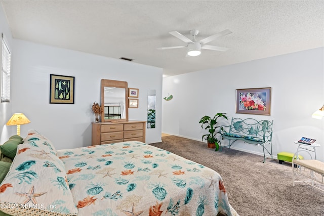 bedroom with ceiling fan, carpet, and a textured ceiling