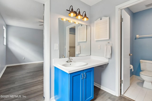 bathroom featuring vanity, toilet, and hardwood / wood-style floors