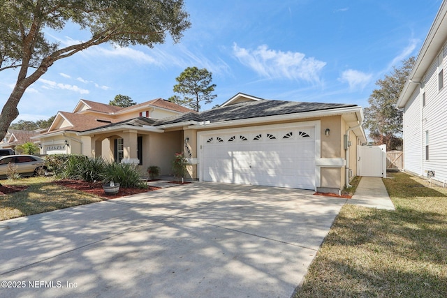 view of front of house featuring a garage and a front lawn