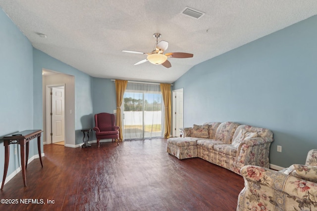 living room with ceiling fan, dark hardwood / wood-style floors, vaulted ceiling, and a textured ceiling