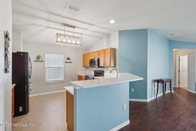 kitchen featuring vaulted ceiling, black / electric stove, fridge, kitchen peninsula, and pendant lighting