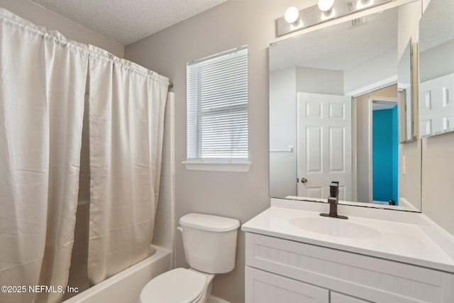 full bathroom with vanity, shower / tub combo, a textured ceiling, and toilet