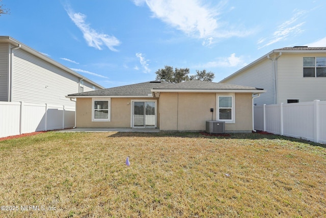 back of property with a patio, a yard, and cooling unit