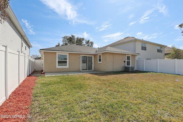 back of house with central AC, a lawn, and a patio area