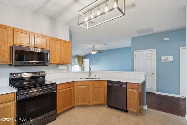 kitchen featuring sink, kitchen peninsula, pendant lighting, ceiling fan, and black appliances