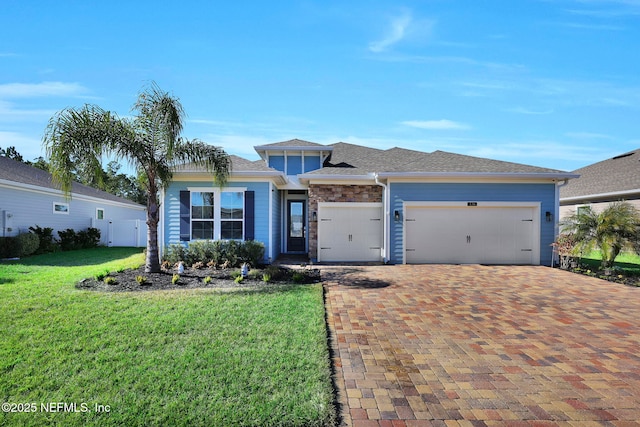 view of front of house with a garage and a front yard