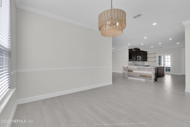 living room featuring ornamental molding, a notable chandelier, and light wood-type flooring