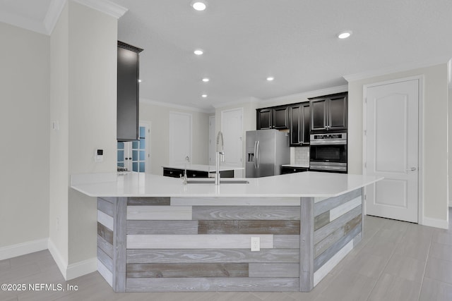 kitchen featuring ornamental molding, appliances with stainless steel finishes, and kitchen peninsula