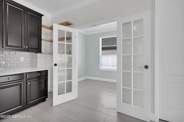 kitchen with crown molding, backsplash, and french doors