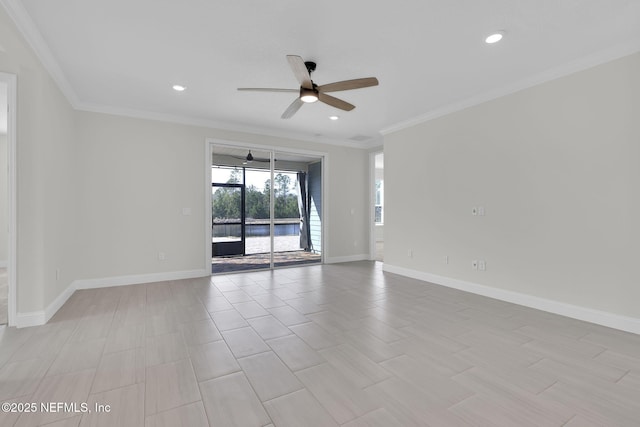 spare room with ornamental molding and ceiling fan