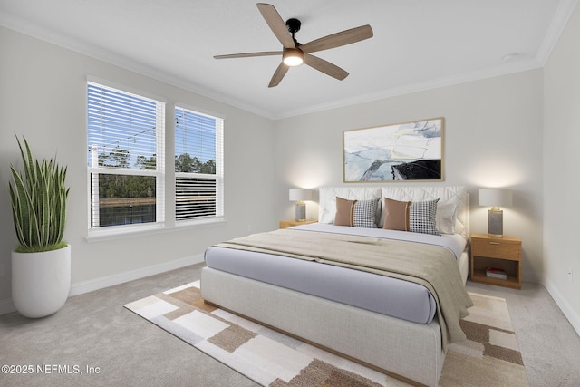 carpeted bedroom with ornamental molding and ceiling fan