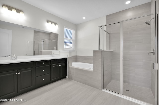 bathroom featuring vanity and plus walk in shower