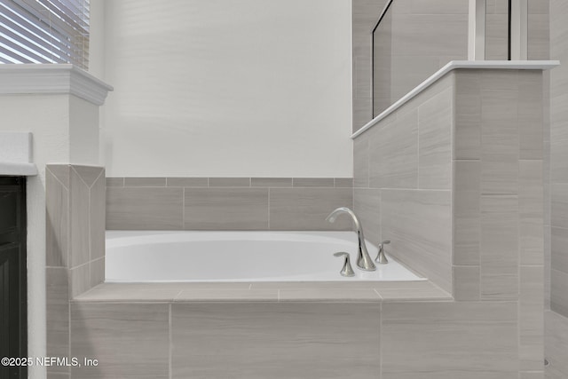 bathroom with vanity and a relaxing tiled tub