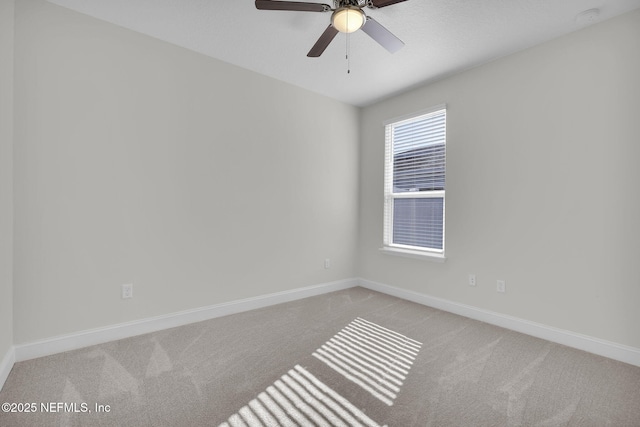 spare room featuring ceiling fan and light carpet