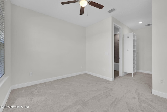 unfurnished bedroom with light colored carpet and ceiling fan