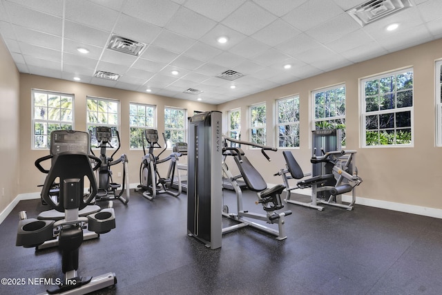 exercise room with a paneled ceiling