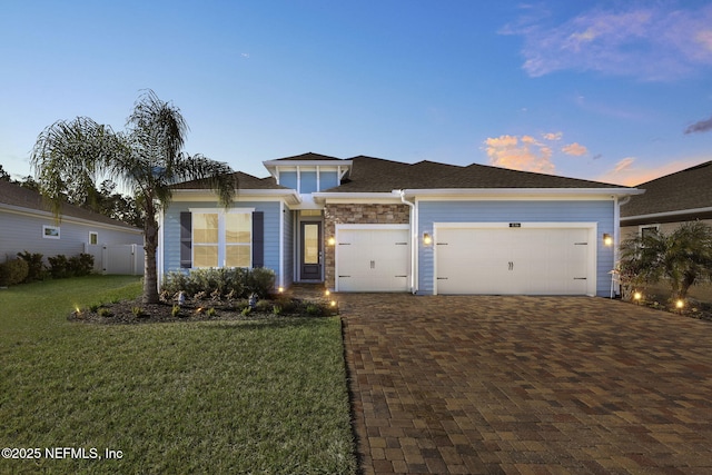 view of front facade with a garage and a lawn