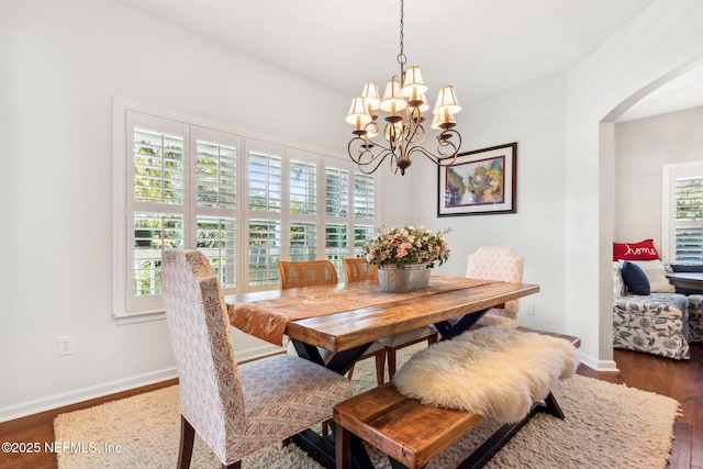 dining room featuring dark wood-type flooring and a chandelier