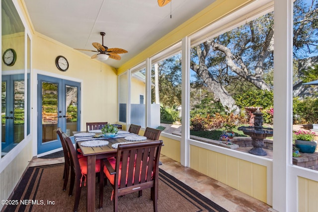 sunroom featuring lofted ceiling, ceiling fan, and french doors