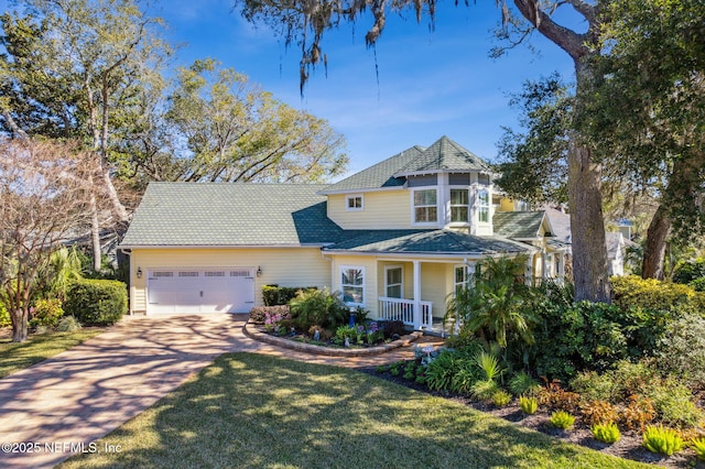 view of front facade featuring a garage and a front lawn