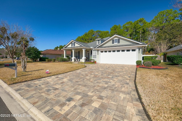 ranch-style house with a garage, a porch, and a front yard