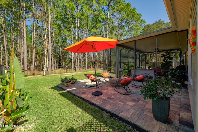 view of patio featuring a sunroom and ceiling fan