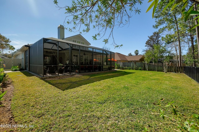 view of yard with glass enclosure