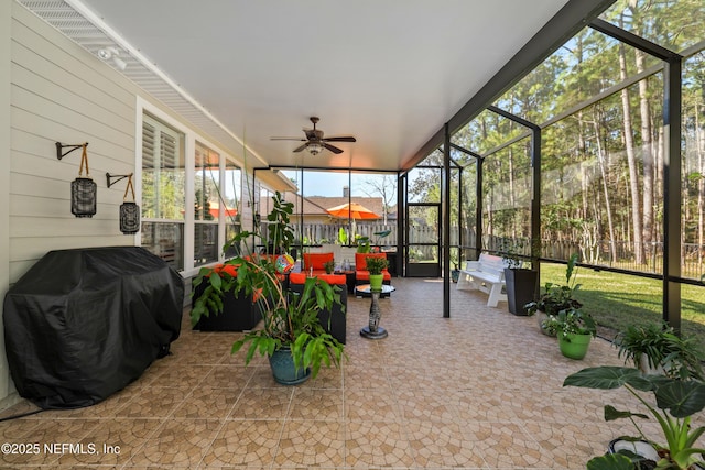 sunroom / solarium featuring ceiling fan