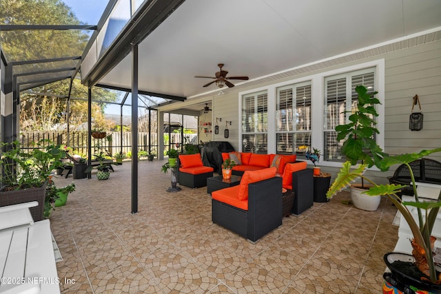 view of patio with an outdoor living space, a lanai, and ceiling fan