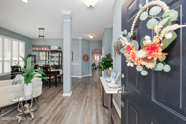 entrance foyer with hardwood / wood-style flooring and a textured ceiling