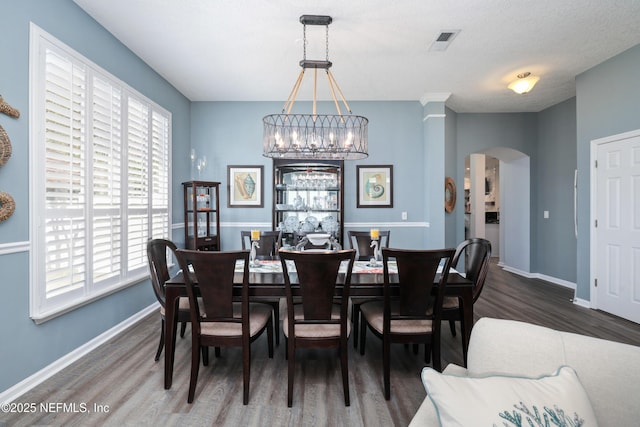 dining space with dark wood-type flooring