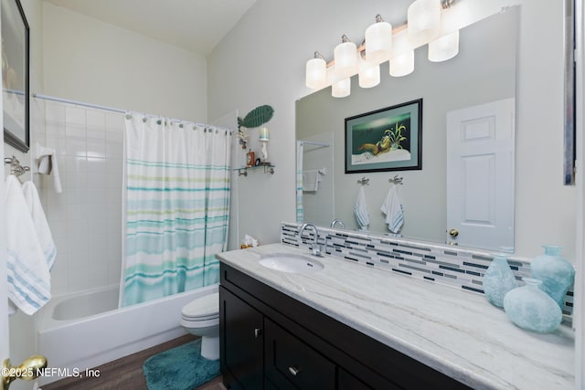 full bathroom featuring hardwood / wood-style flooring, backsplash, vanity, toilet, and shower / bath combo with shower curtain